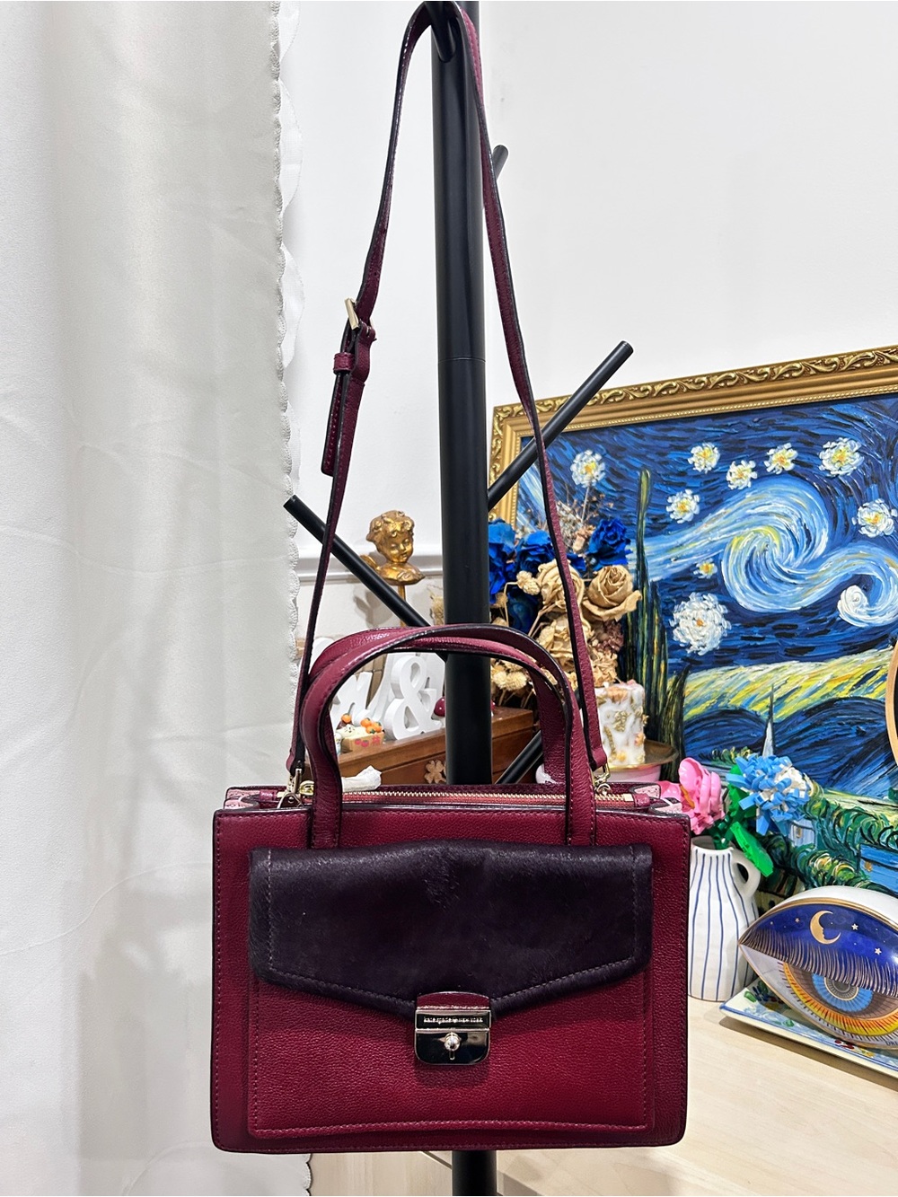 Kate Spade Burgundy leather handbag with gold hardware and adjustable strap